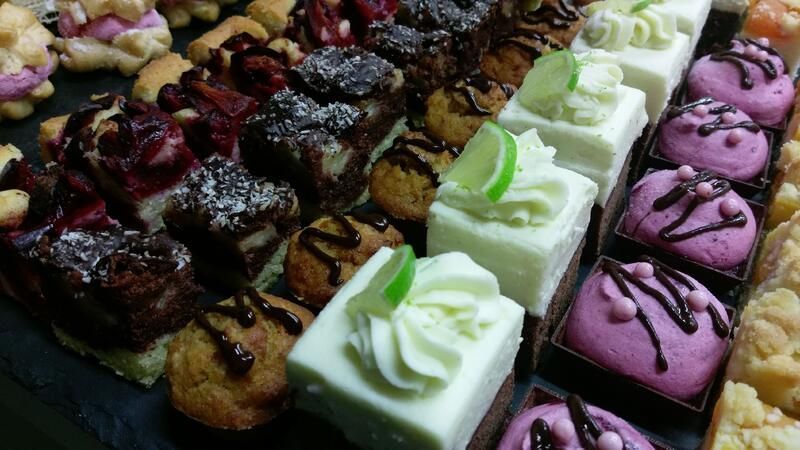 Es stehen viele verschiedene Dessertsorten auf dem Tisch.