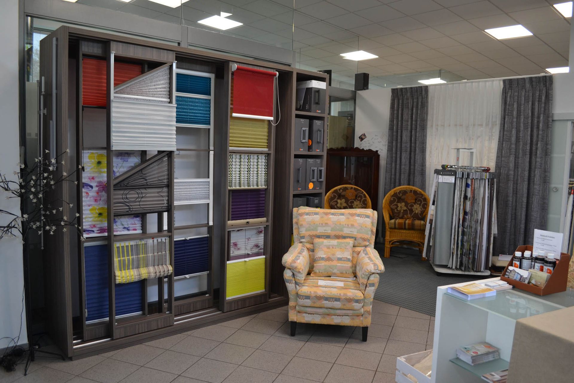 In einem Raum mit einer Stoffausstellung steht ein Stuhl.