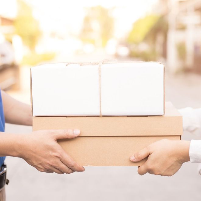 Racchetta e palla da tennis su un campo in terra battuta, che proiettano una lunga ombra alla luce del sole.