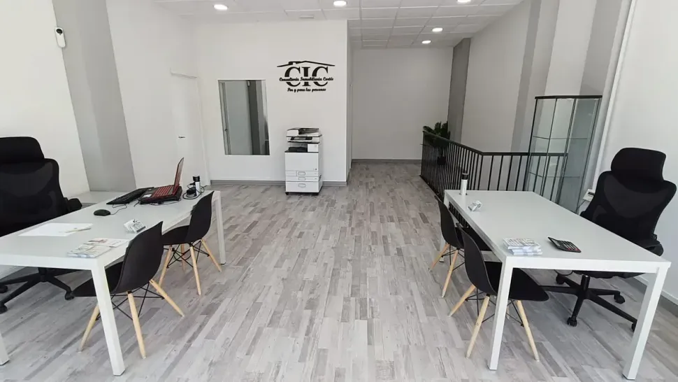 Una habitación con muchas mesas y sillas.