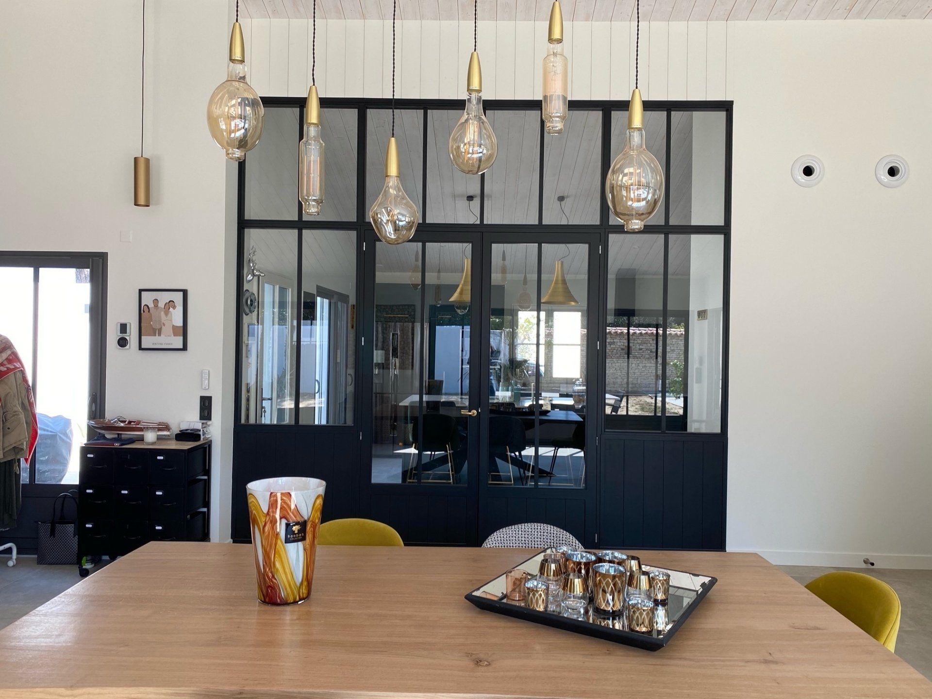 Table en bois au premier plan et baie vitrée en arrière-plan