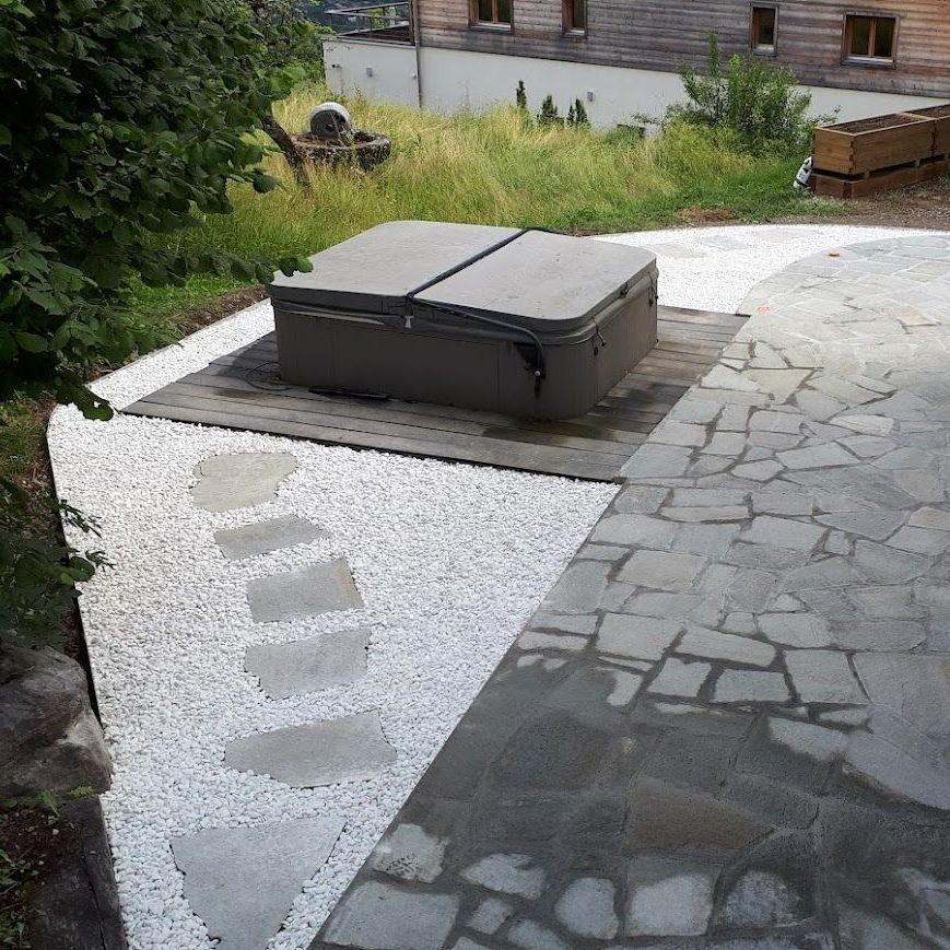 Une terrasse dallée avec un cheminement en pierre