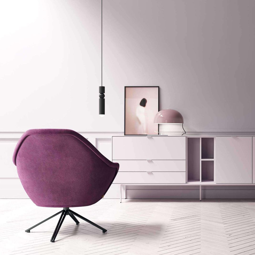 Una silla morada está en una sala de estar al lado de una cómoda blanca.