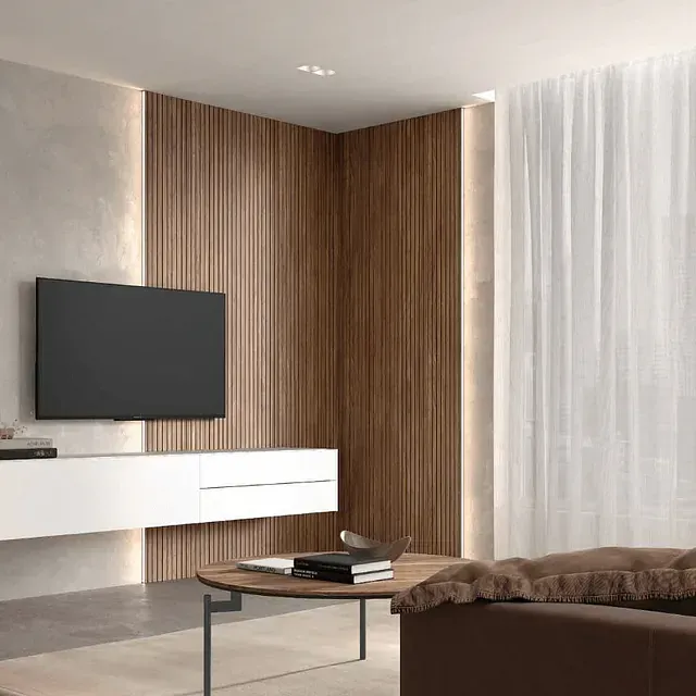 Una sala de estar con un sofá y un televisor de pantalla plana.