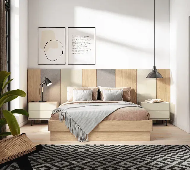 Un dormitorio con una cama, mesitas de noche y una alfombra.