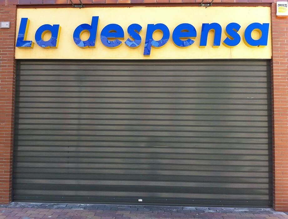 Un escaparate con un cartel amarillo que dice la despensa