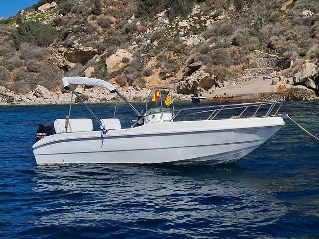 Un barco blanco flota sobre un cuerpo de agua.
