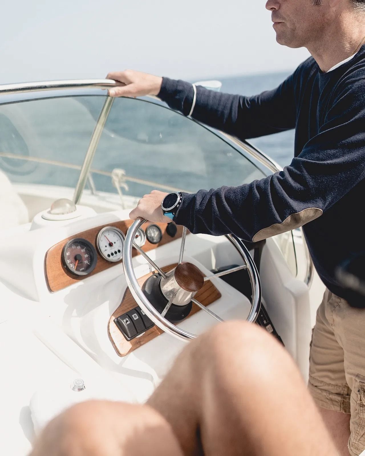 Un hombre conduce un barco en el océano.