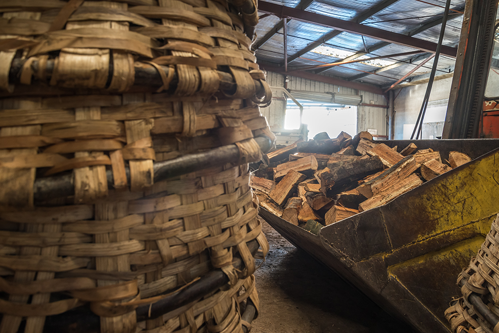 Un panier en osier avec une pelleteuse remplit de bois