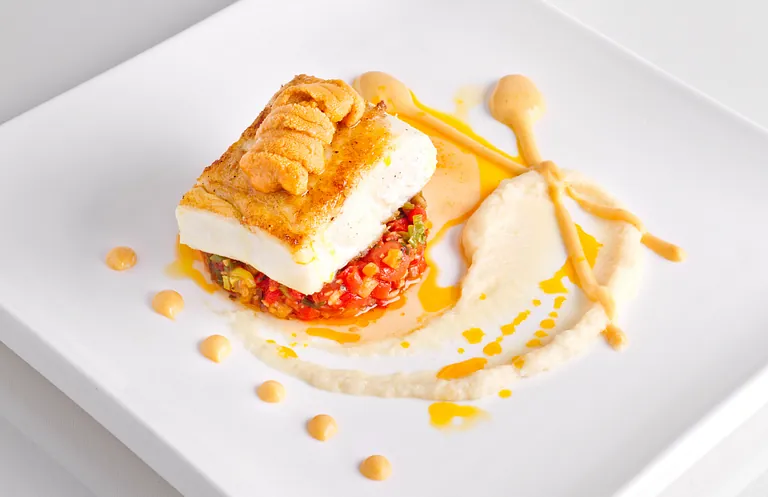 Un plato blanco con un trozo de comida encima.