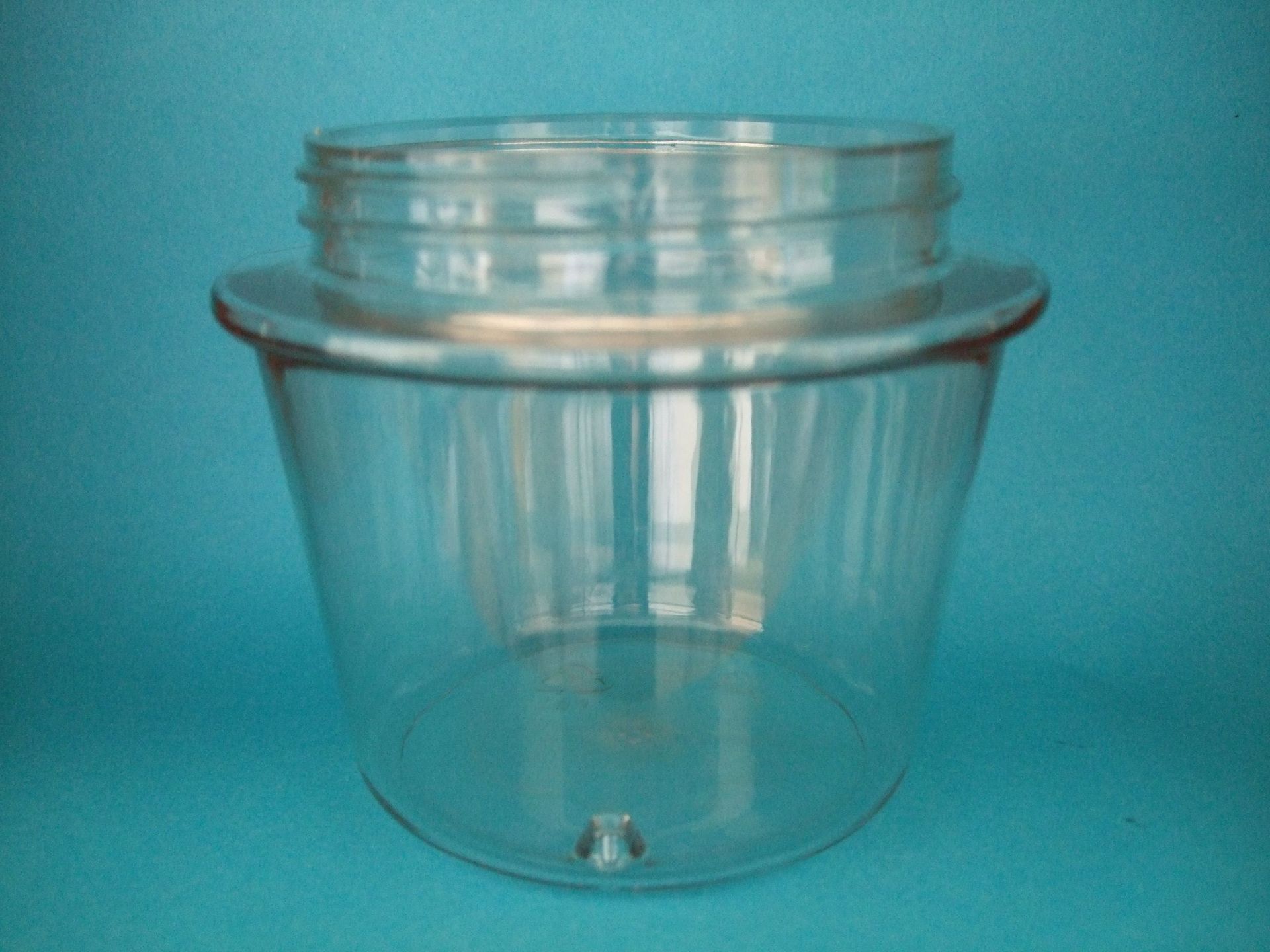 Gobelet en plastique transparent avec couvercle à visser sur fond turquoise