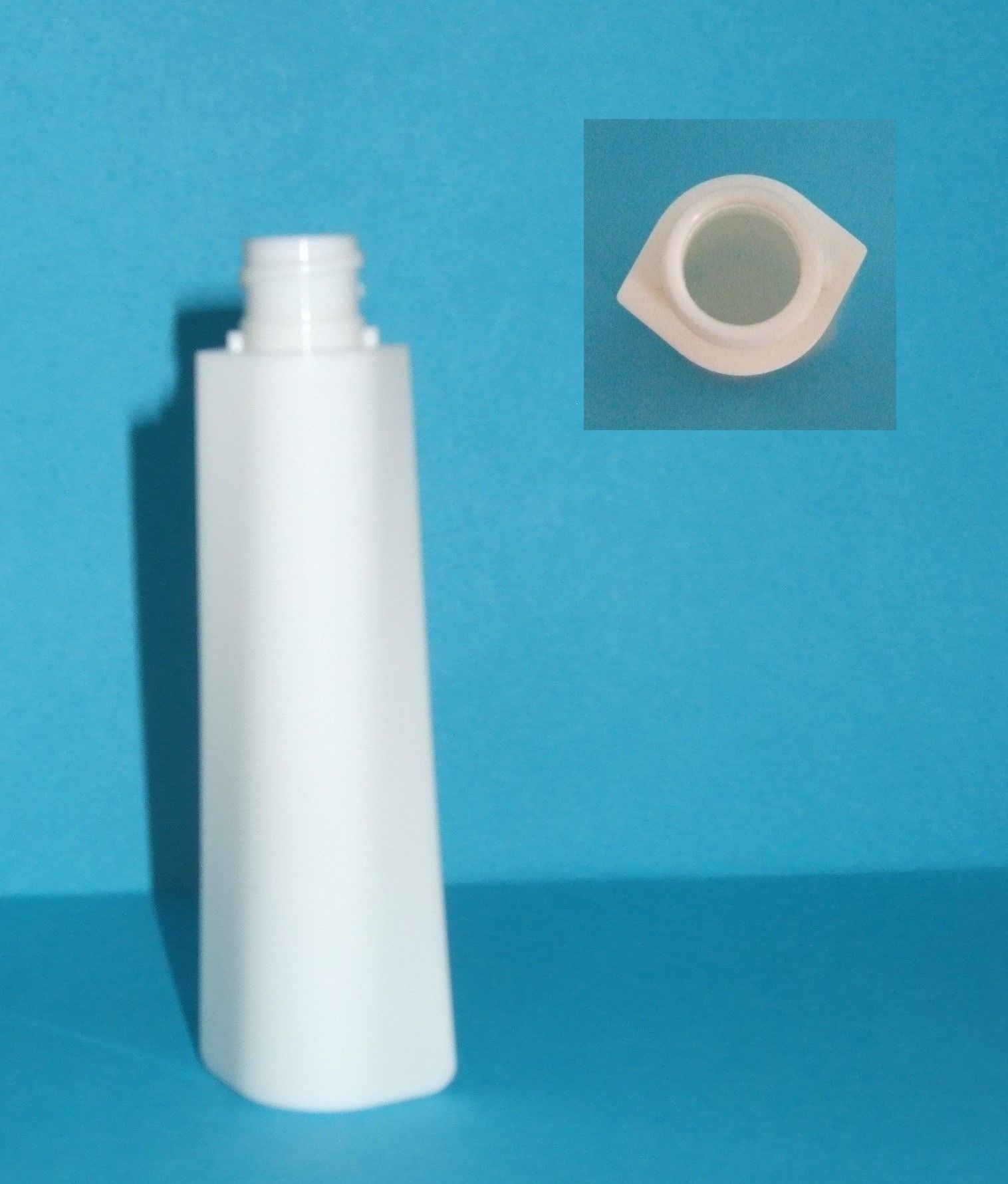 Bouteille en plastique blanc sans bouchon, représentée sur fond bleu avec un petit encart montrant l'ouverture.
