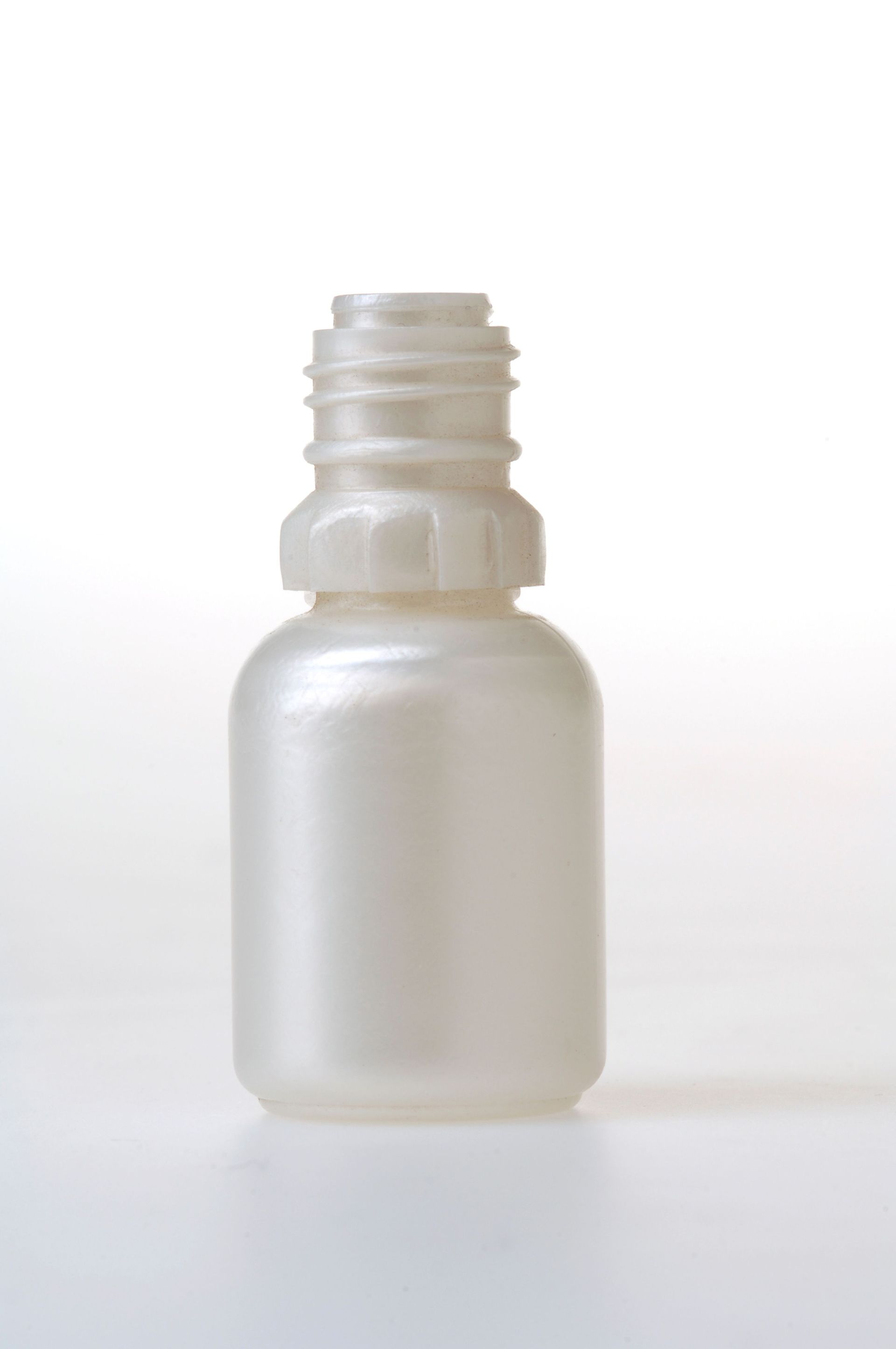 Petit flacon cosmétique blanc dépoli avec un col fileté ouvert sur fond blanc