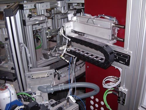Nahaufnahme einer industriellen Automatisierungsanlage mit modularem Aluminiumrahmen, Verkabelung.