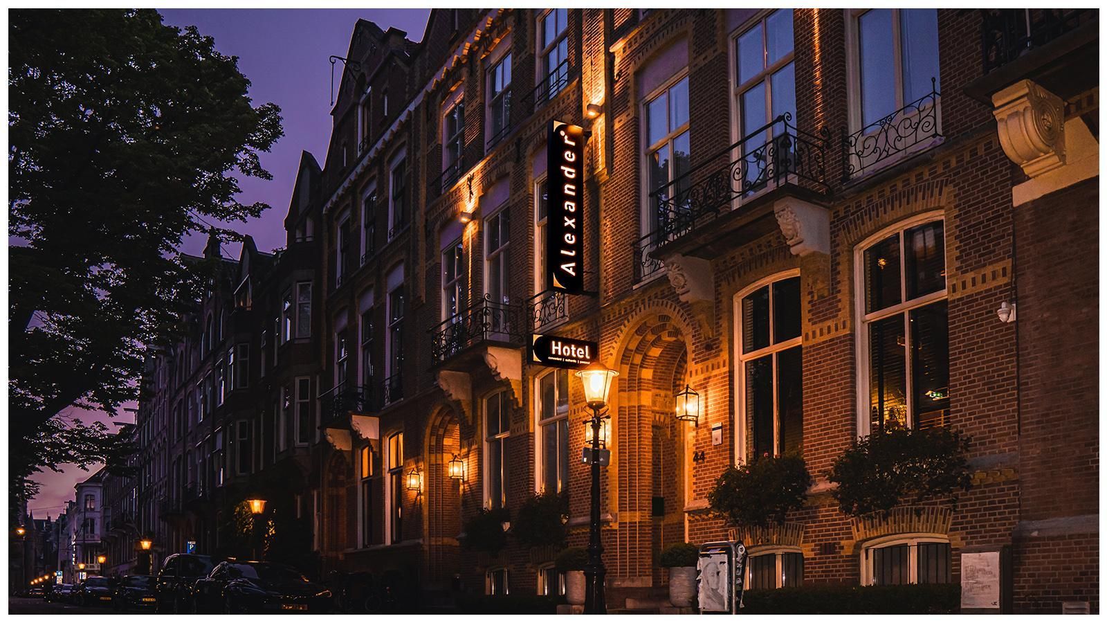 A brick building with a sign that says ' amsterdam ' on it