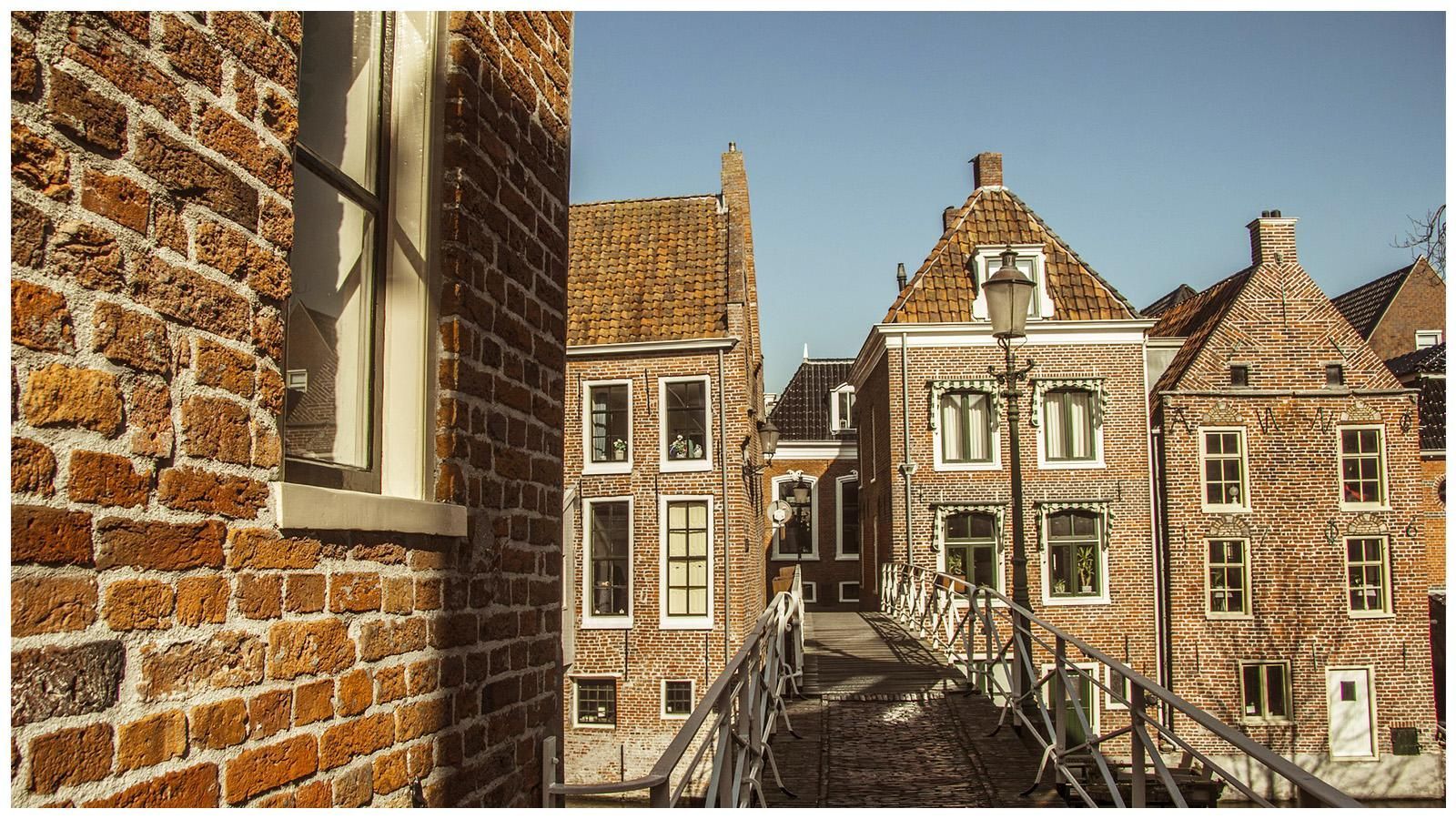 A brick building with a bridge in front of it