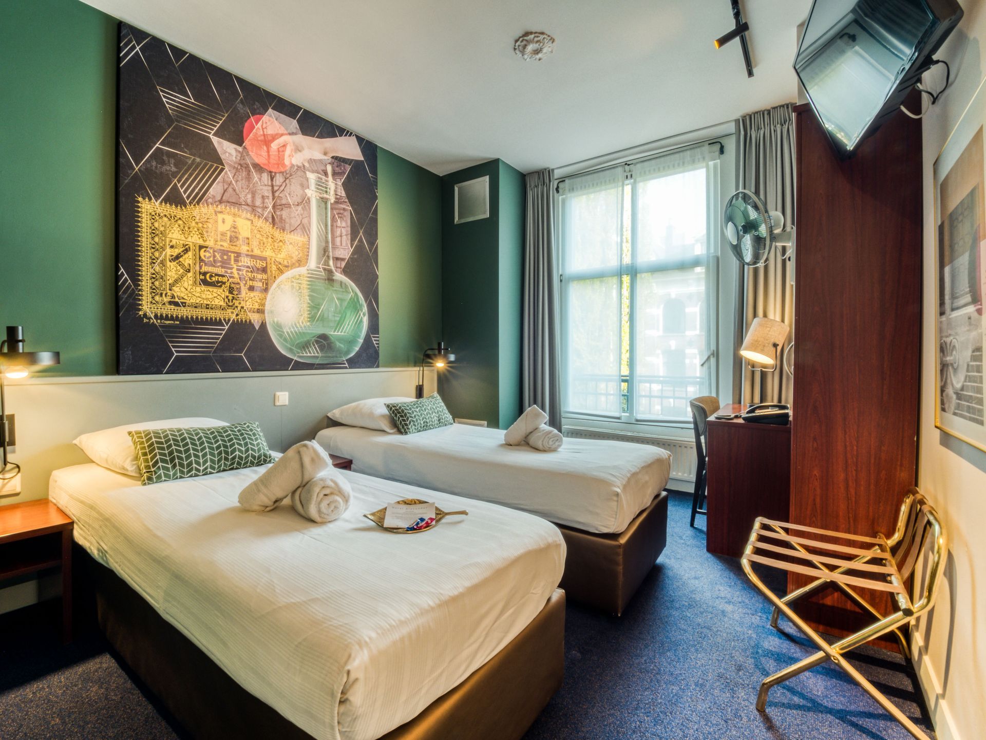 Twin room with two single beds, wall art and large windows