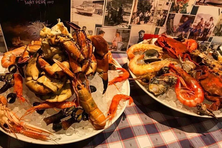 Dos platos de mariscos están sobre hielo sobre una mesa.