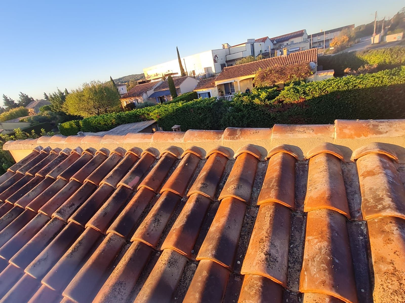 Gros plan sur des tuiles de terre cuite orange par une journée ensoleillé.