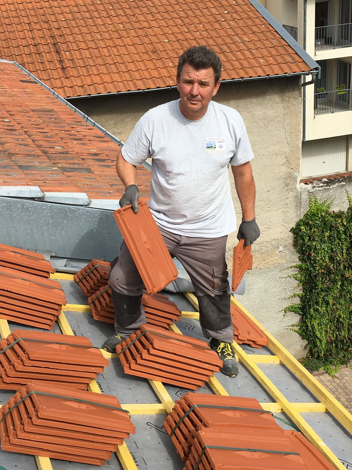Artisan couvreur de l'entreprise Naveri qui pose des tuiles