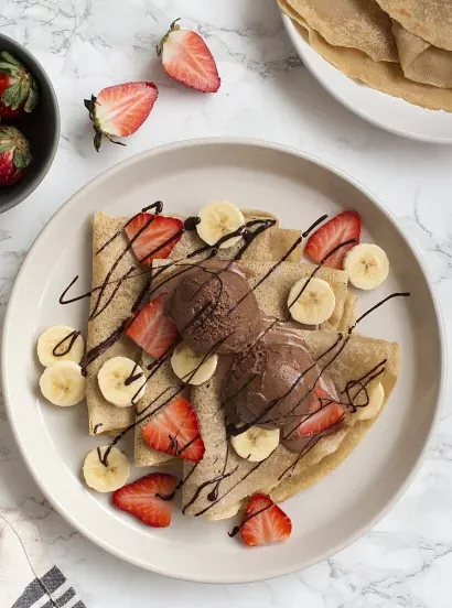 Un plato de comida con plátanos y fresas encima.