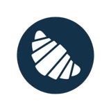 Un icono de croissant en un círculo azul sobre un fondo blanco.