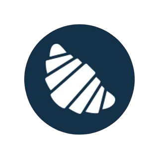 Un icono de croissant en un círculo azul sobre un fondo blanco.