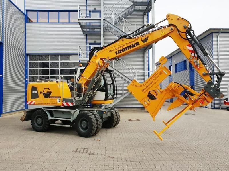 Ein gelber Liebherr-Bagger steht vor einem Gebäude