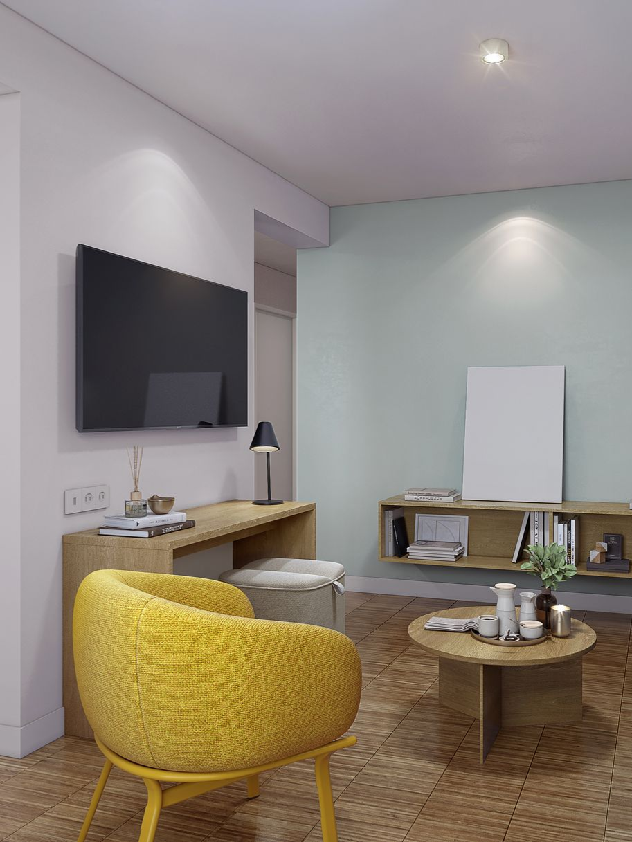Gemütliches Wohnzimmer mit gelbem Sessel, Fernseher, blauem Sofa und offener Tür zum Essbereich.