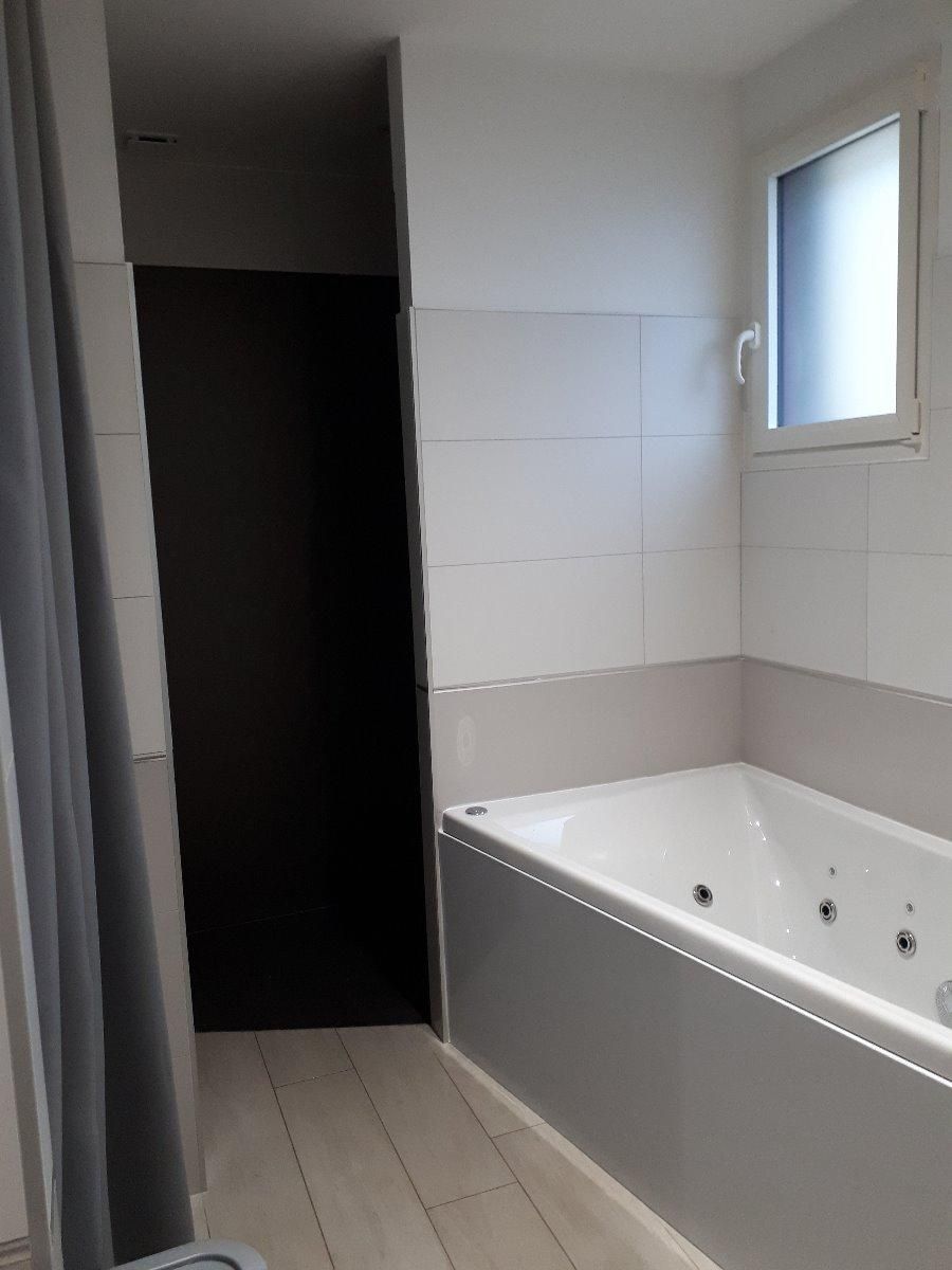 Salle de bains grise et blanche avec baignoire