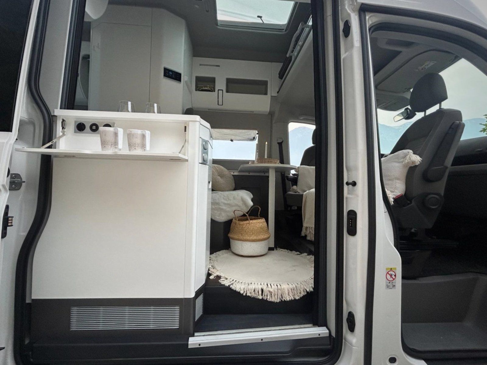 Das Innere eines weißen Lieferwagens mit offener Tür.