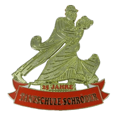 A 25 jahre tanzschule schroeder pin with a man and woman dancing