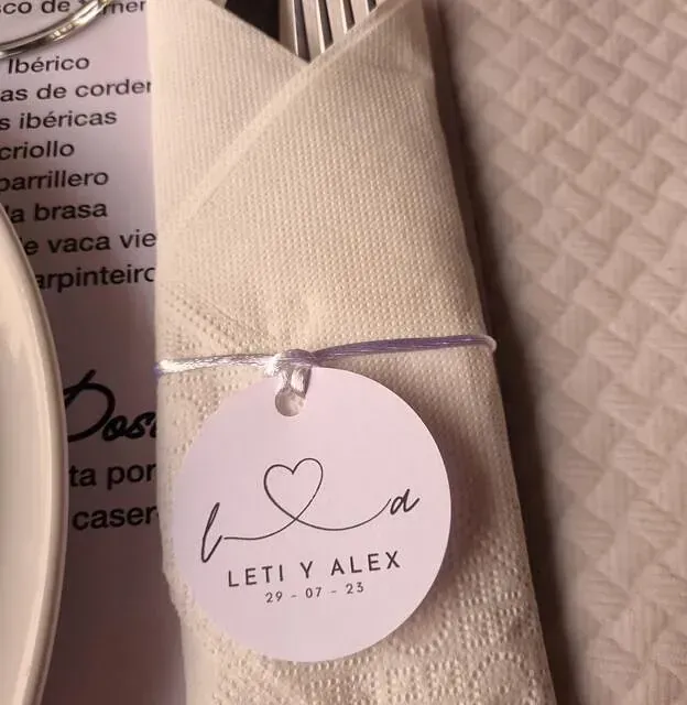 Una servilleta con una etiqueta que dice Leti y Alex.