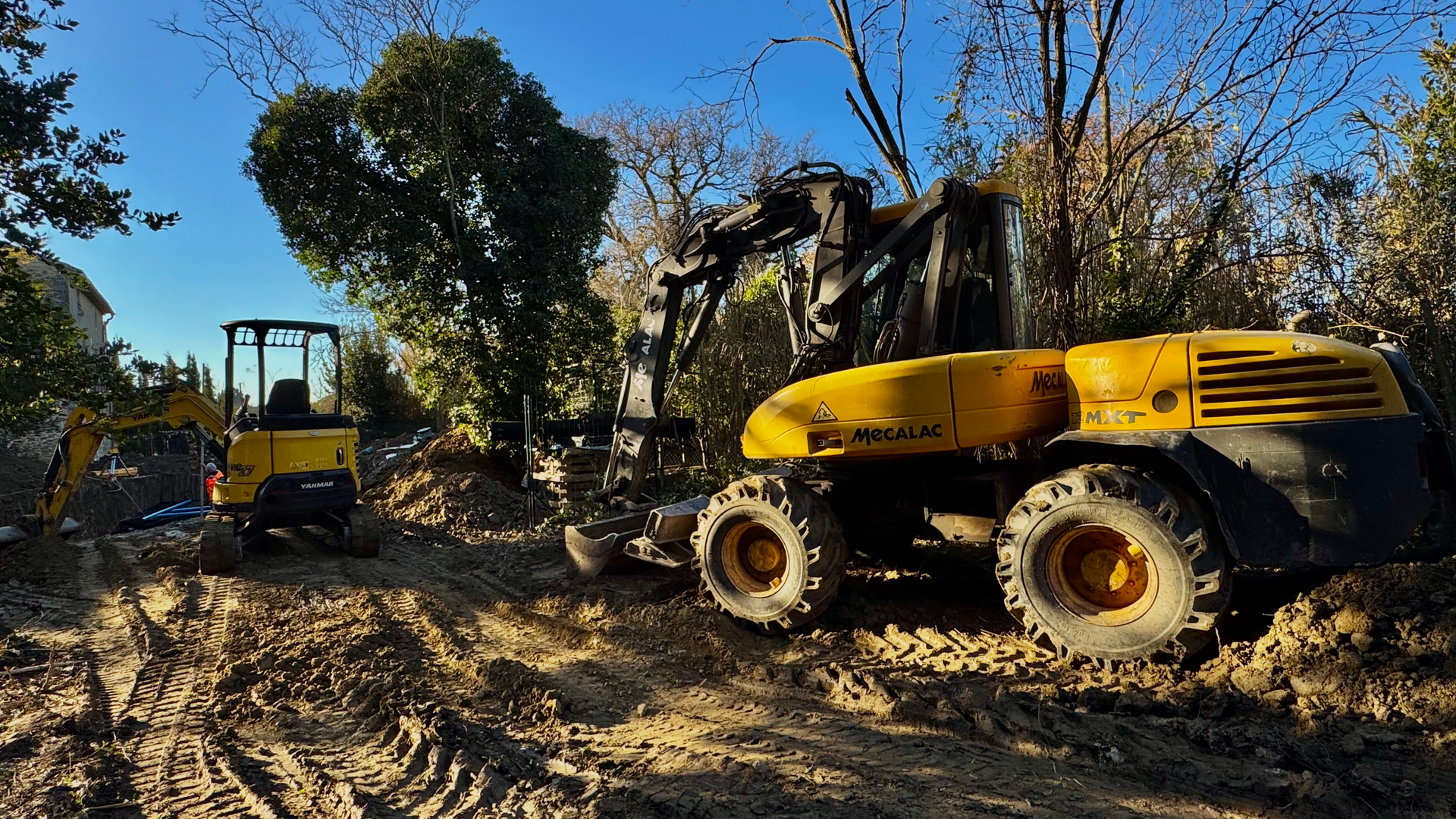 Engins de chantier, une pelle Yanmar et une pelle Mecalac, en action pour des travaux d’assainissement et de terrassement à Caumont.