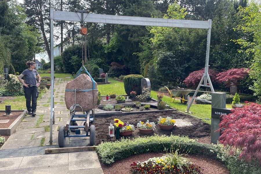A large rock is sitting on the back of a truck.