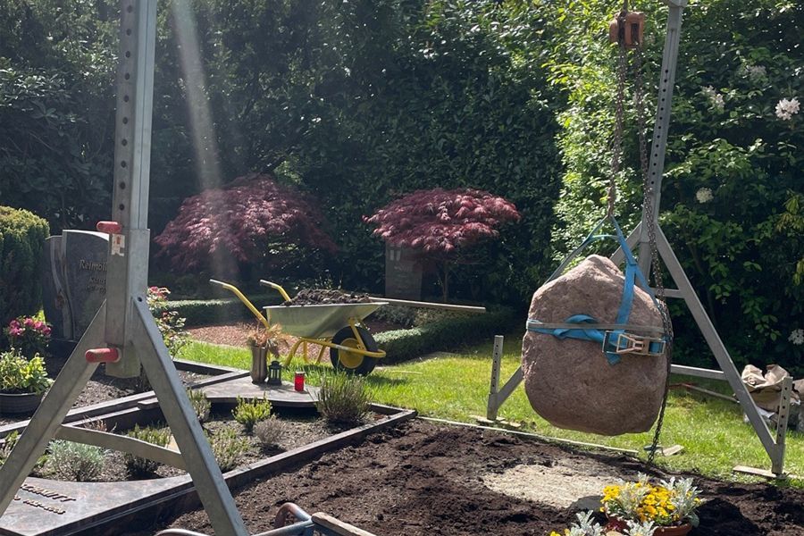A large rock is sitting on the back of a truck.