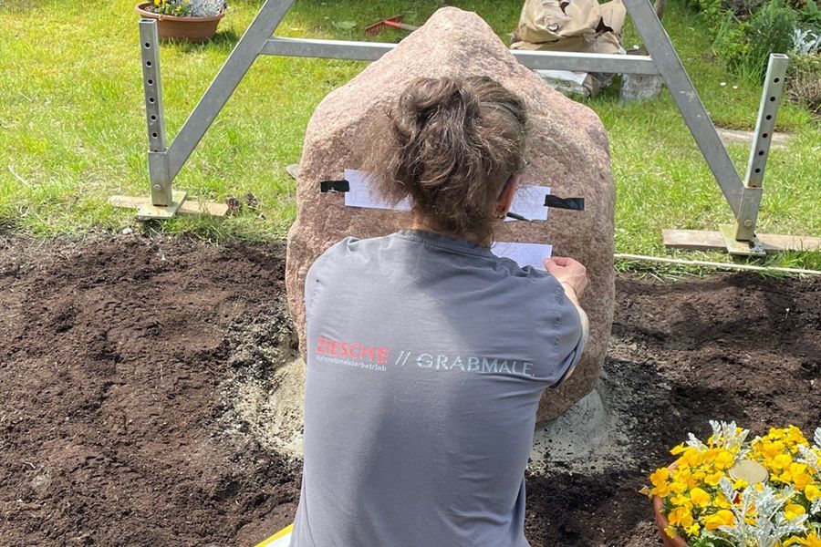 A large rock is sitting on the back of a truck.