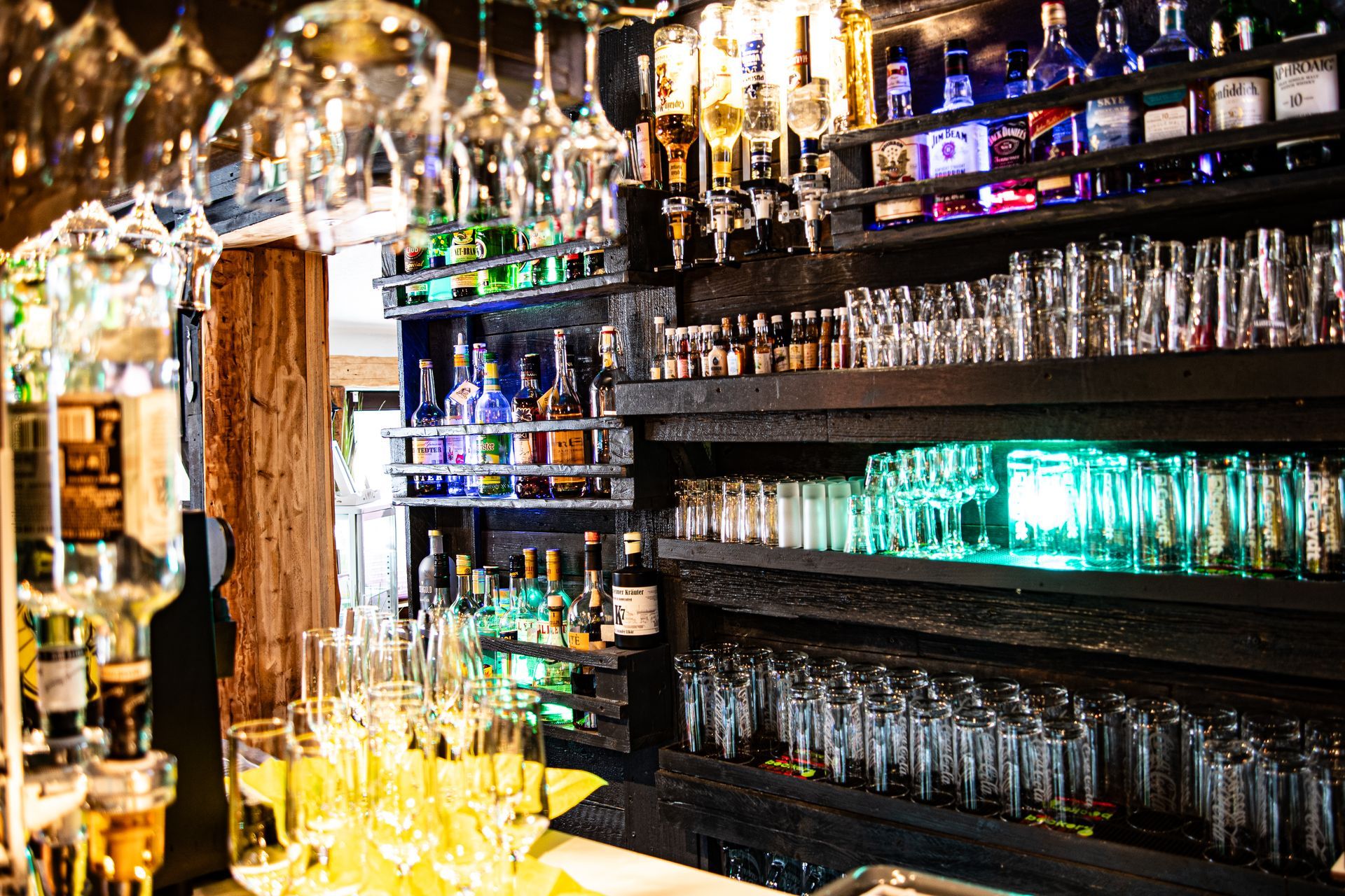 Eine Bar voller Gläser und Flaschen Alkohol.
