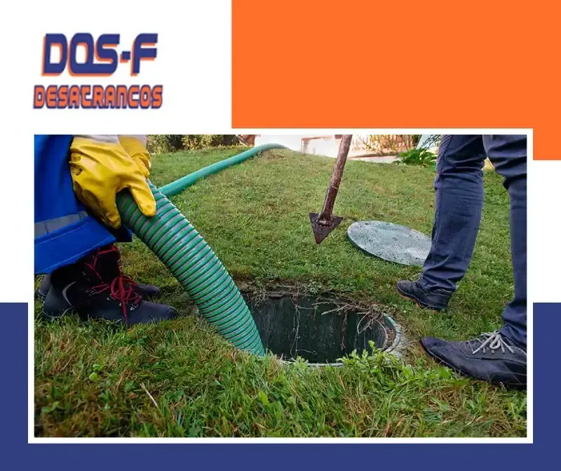 Un hombre está bombeando aguas residuales a un pozo con una manguera verde.