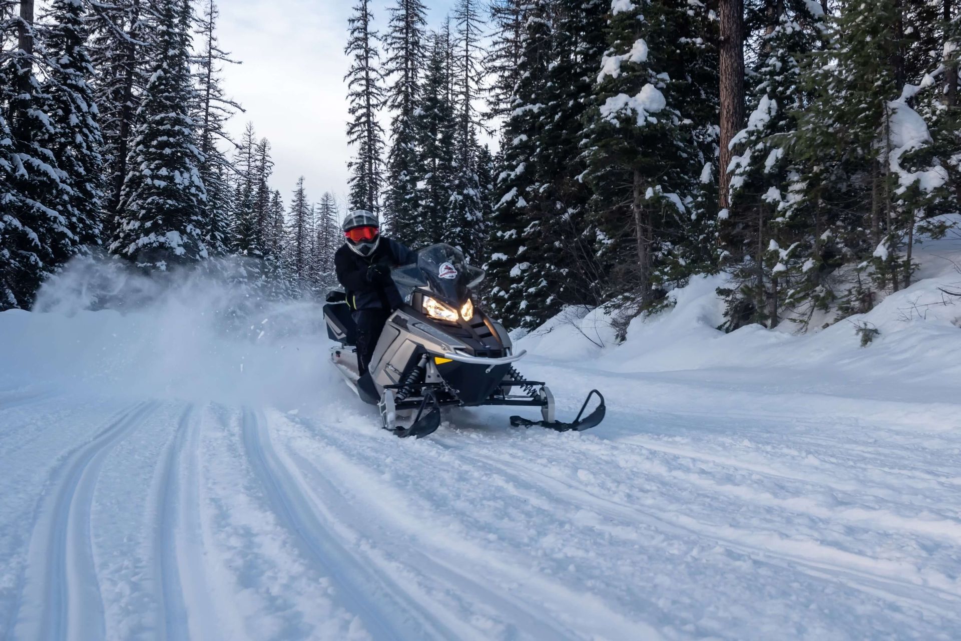 A person snowmobiling in Big Sky, Montana.