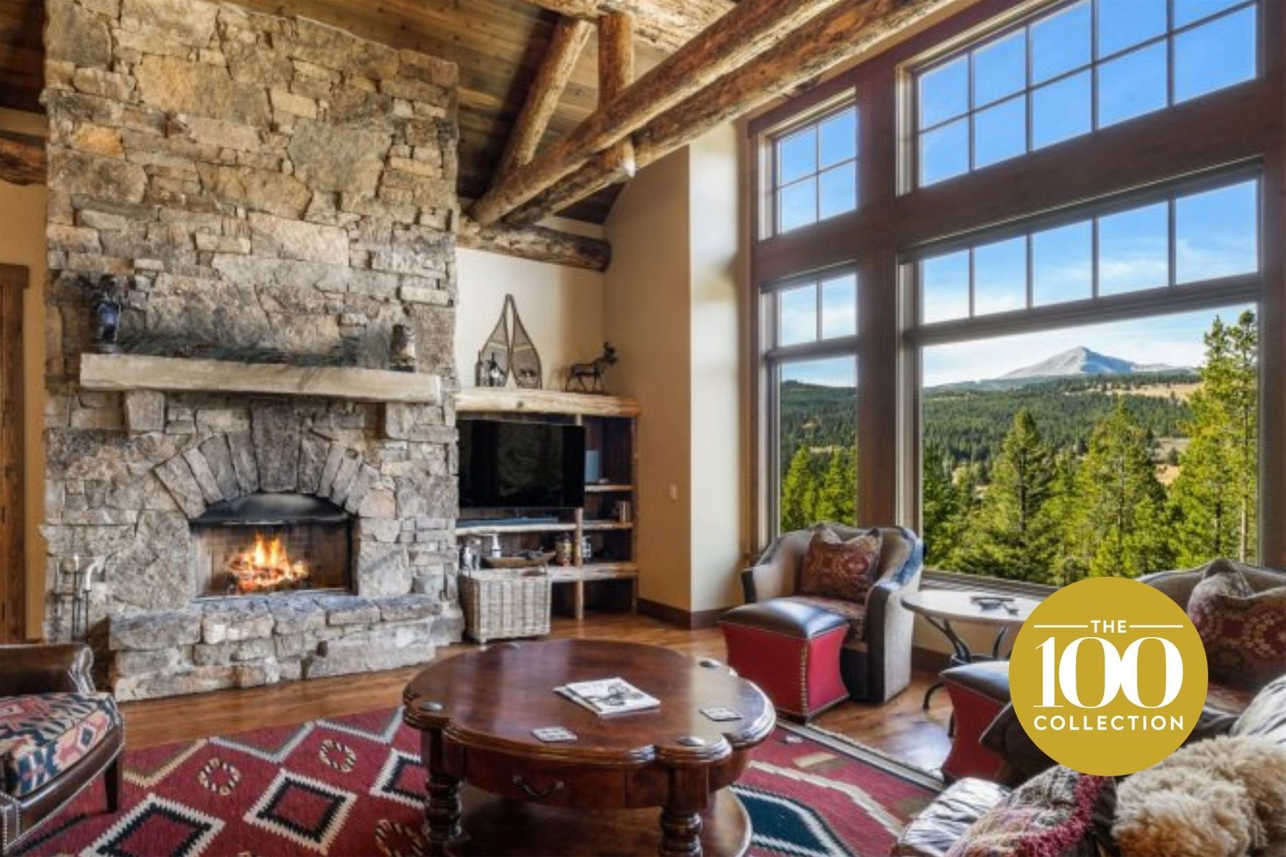 A living room with a fireplace and a large window.