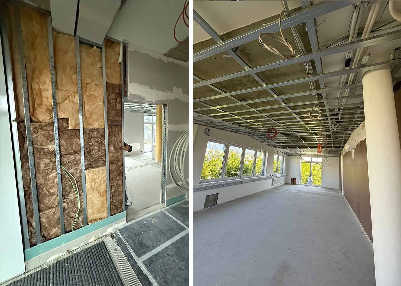 Innenbereich im Umbau mit freiliegender Dämmung, Rahmenkonstruktion und unfertiger Decke in einem langen Flur