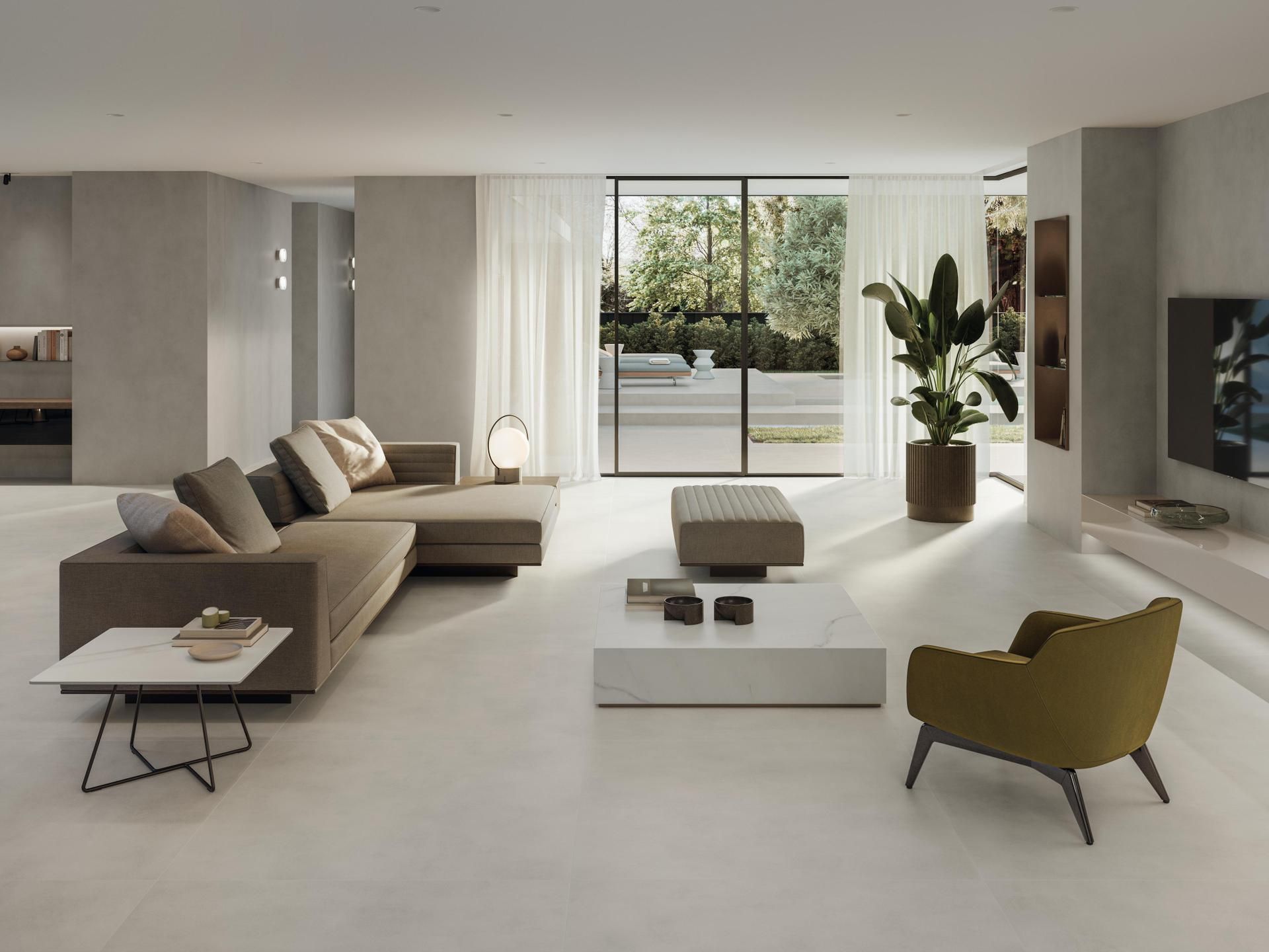 Salon moderne et minimaliste avec canapé d'angle beige, fauteuil vert, table basse blanche et grandes fenêtres.