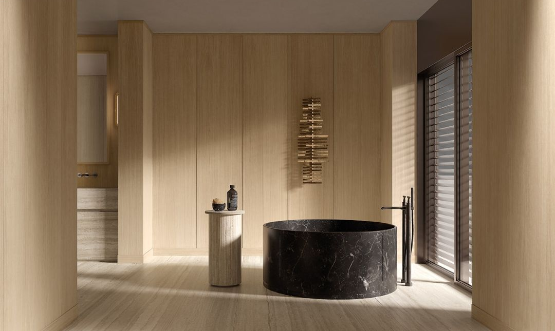 Salle de bains moderne avec meuble-lavabo suspendu, miroir rond et douche en verre attenante à la baignoire.