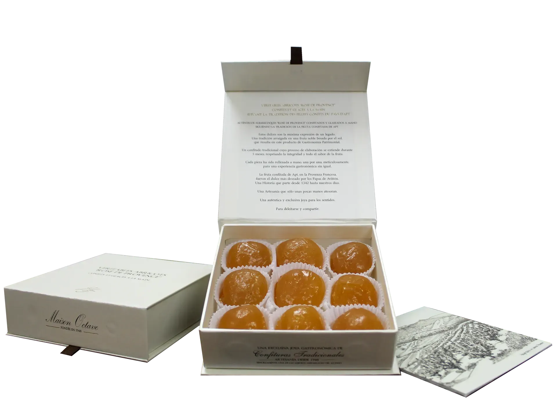 Caja blanca abierta de caramelos redondos de color naranja con tapa, folleto y tarjeta al lado.