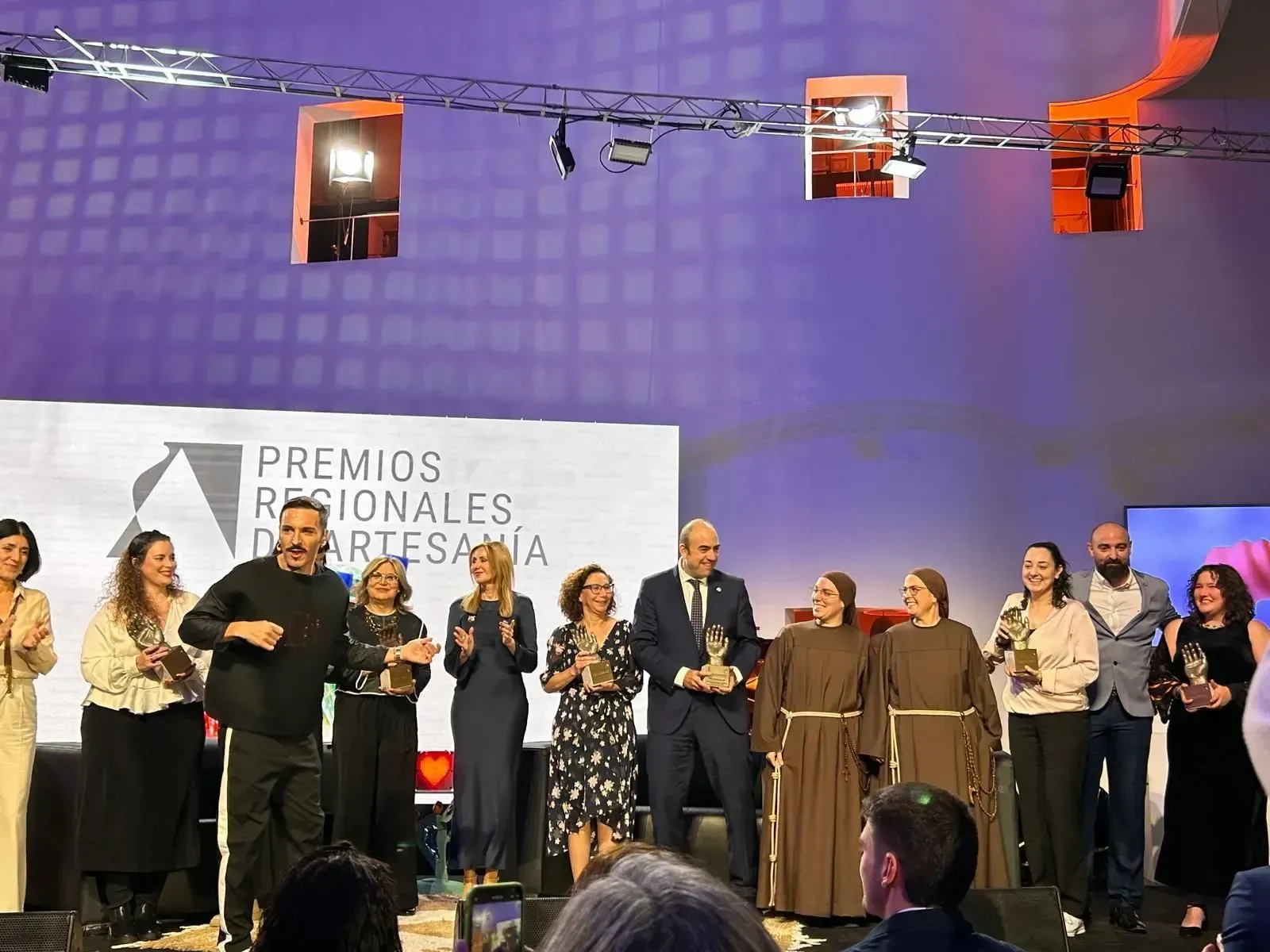 Personas en un escenario sosteniendo premios en la fiesta de los Premios Nacionales