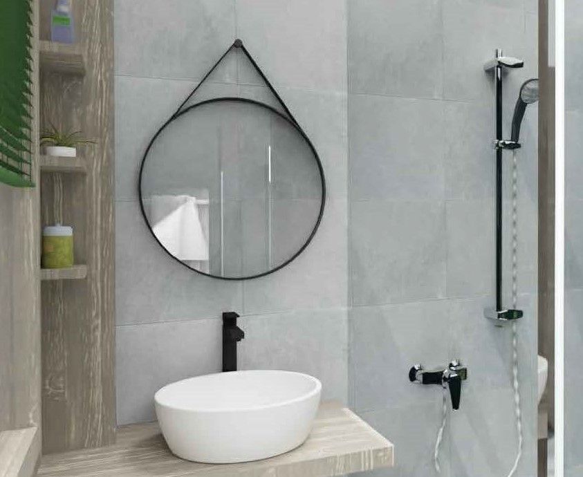 Une salle de bain avec lavabo , miroir et douche.