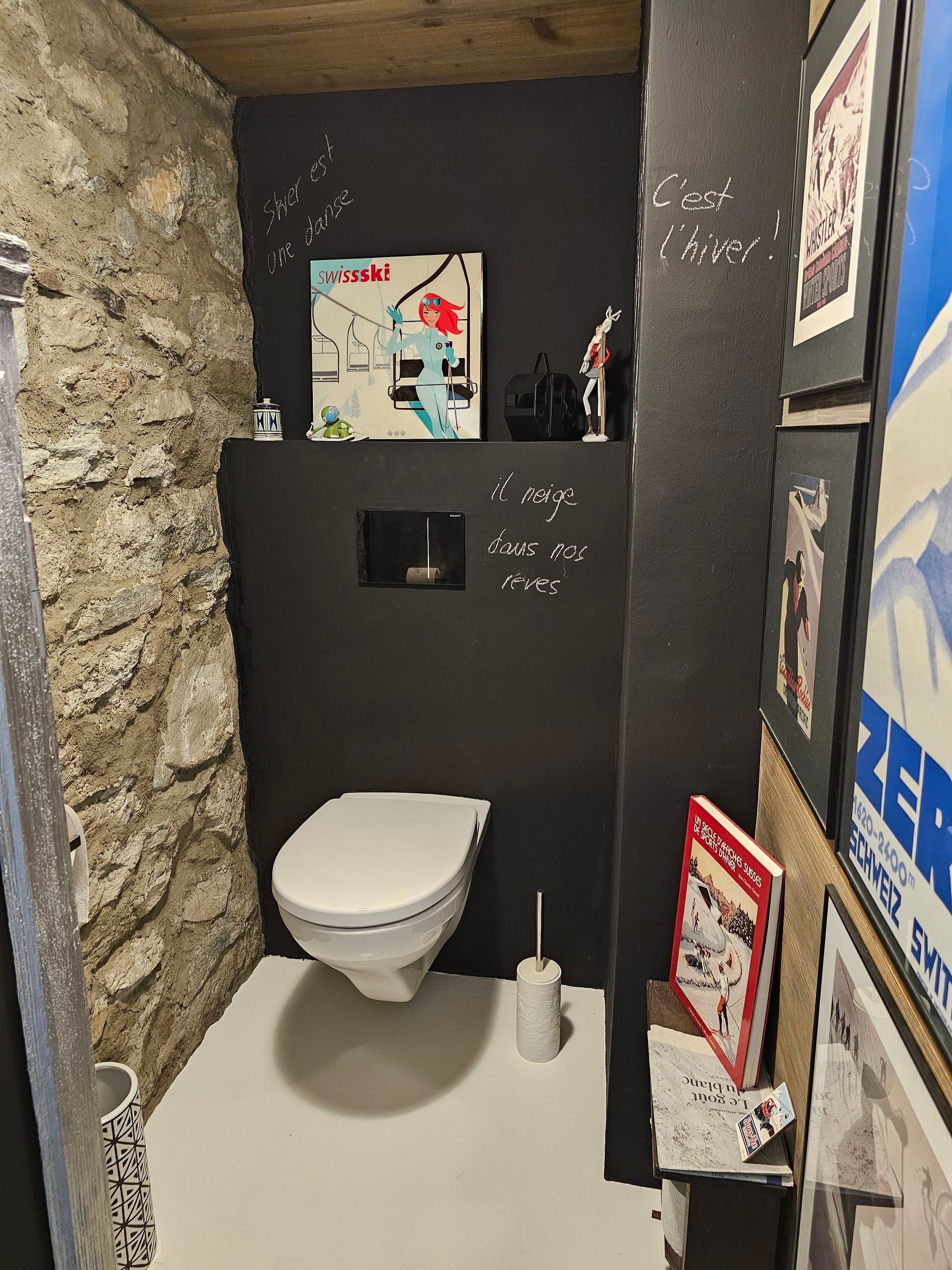 Une salle de bain avec toilettes et un tableau au mur