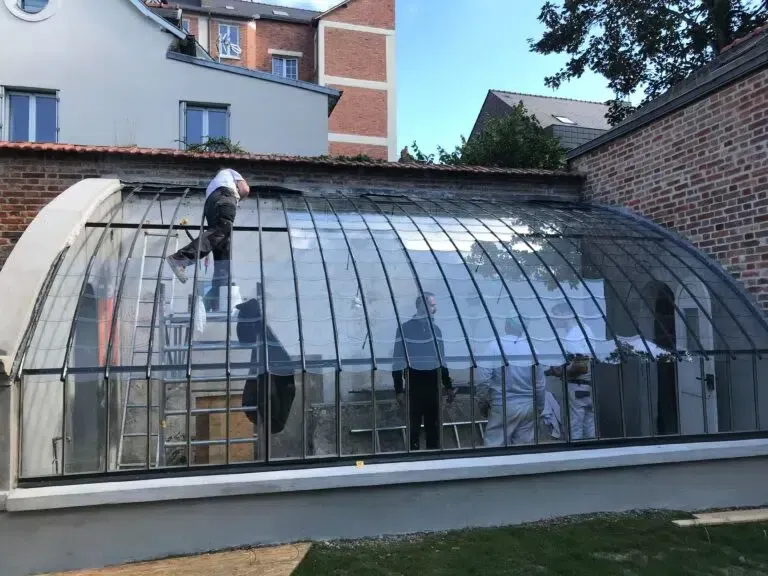 Une équipe qui installe des vitres sur une structure en métal