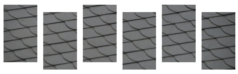 Des sections de bardeaux gris foncé, probablement sur un toit.